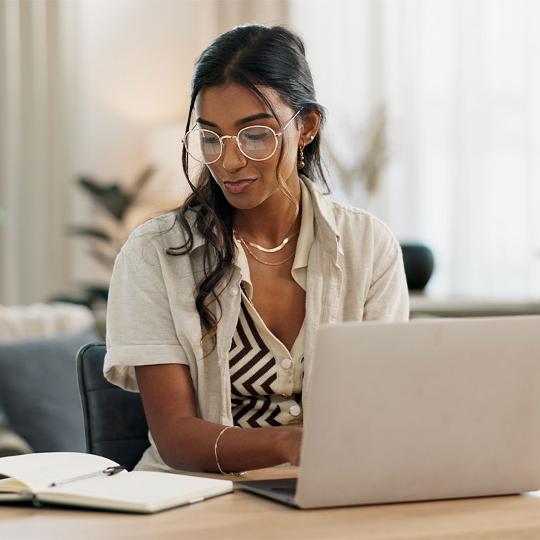 woman typing from notes