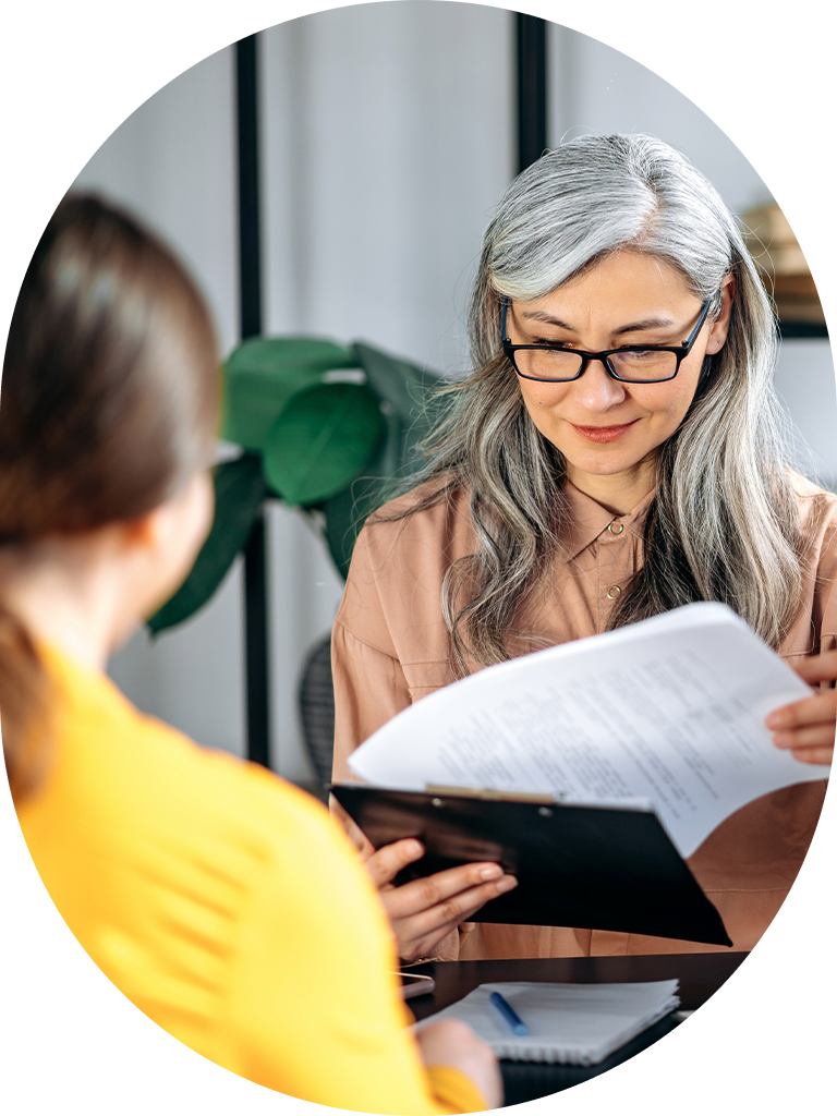 woman looking at paperwork in a meeting